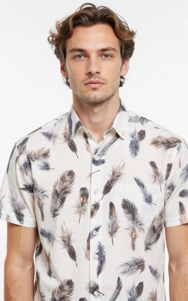 A French model wearing a Feather pattern   printed shirt, against a white background, in a front   facing bust portrait